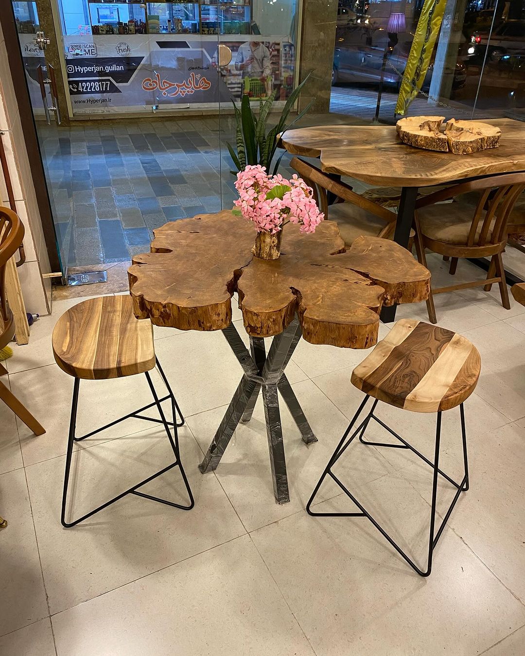 Rustic wooden table with matching stools in a cafe