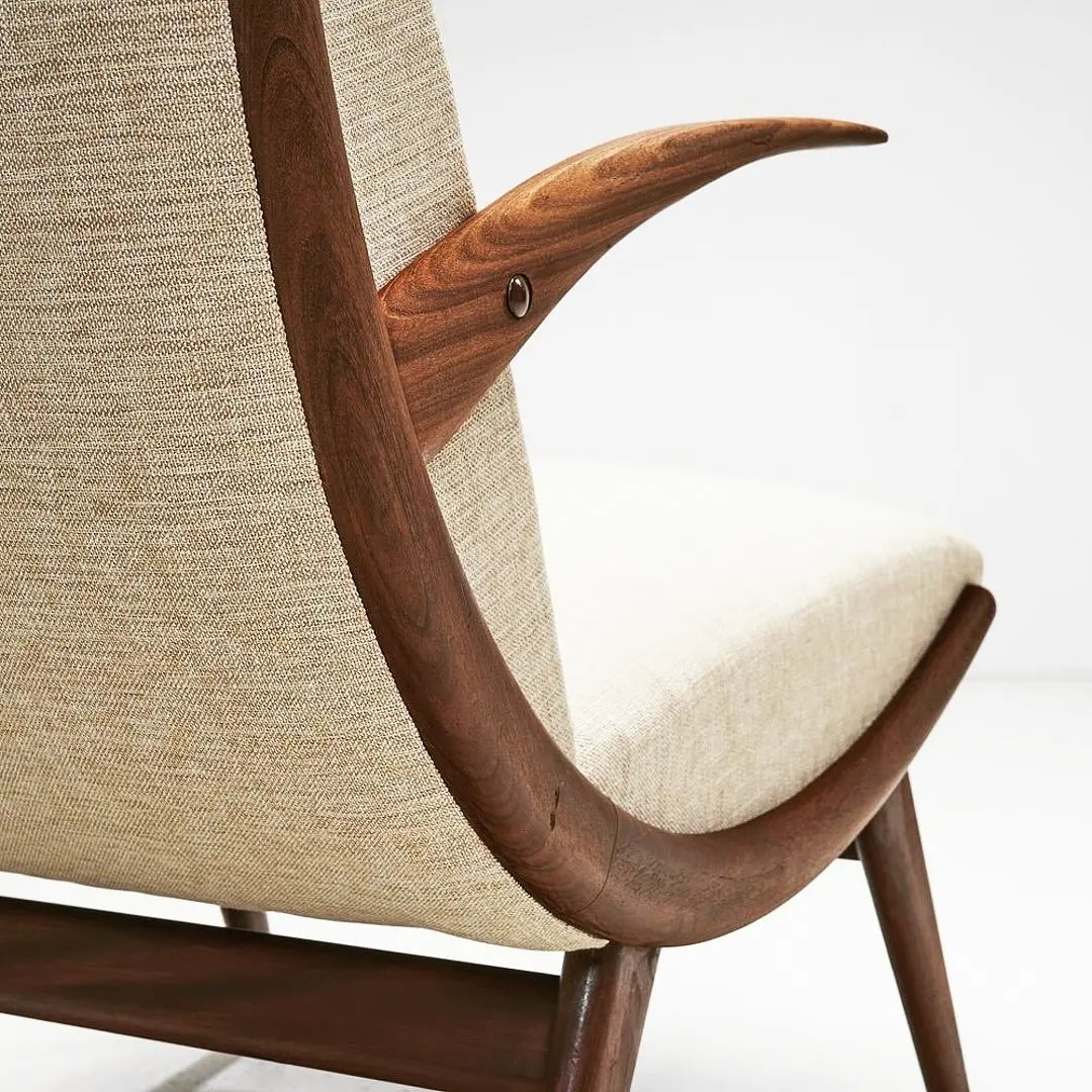 A finely crafted wooden chair with a textile backrest and seat