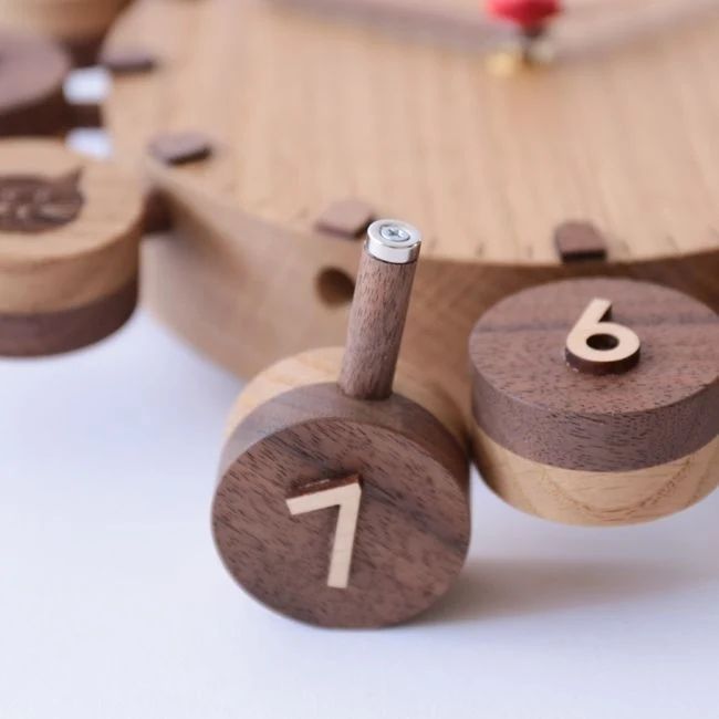 Wooden clock with numbered pegs