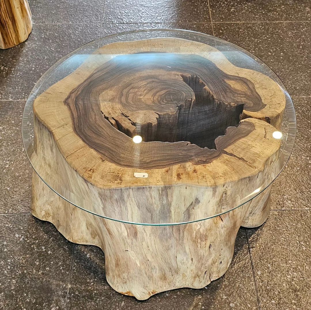 A unique wooden coffee table with a clear glass top