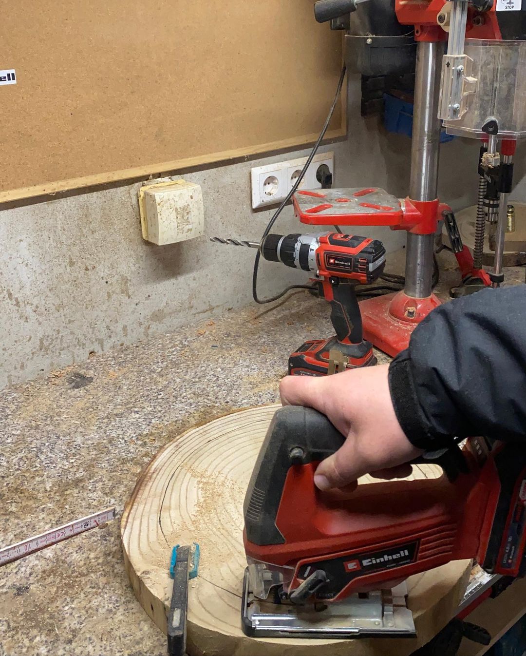 A person using a jigsaw on a circular piece of wood