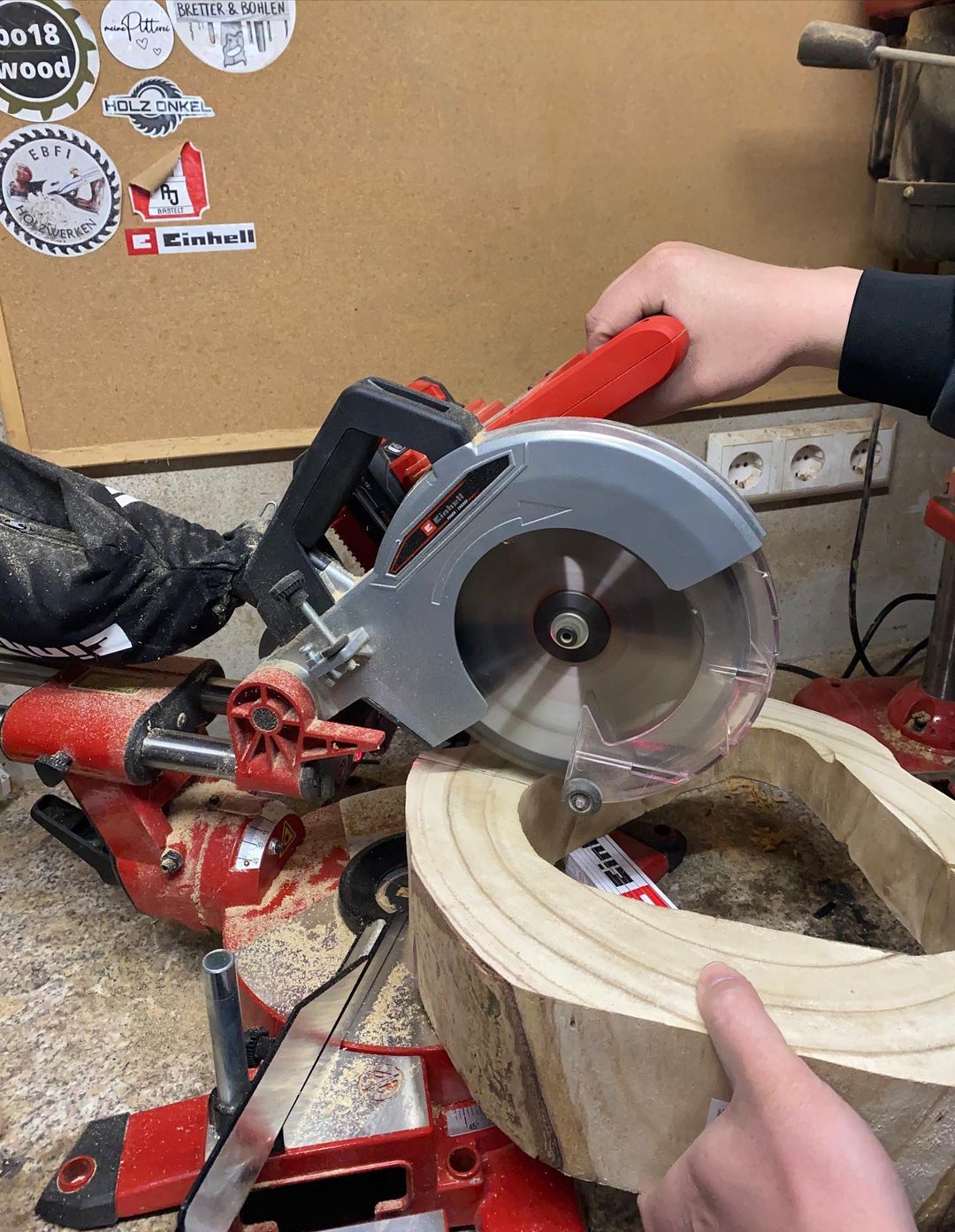 Person using a circular saw to cut through wood