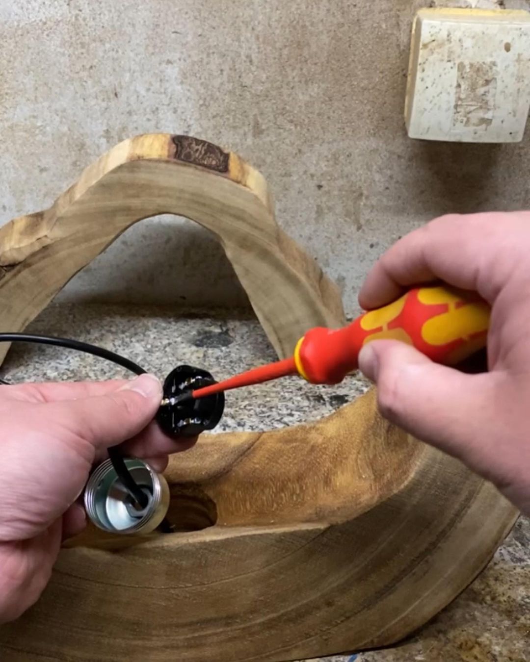 Person installing a light fixture