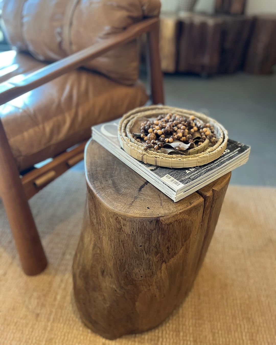 A cozy living room setup with a rustic wooden stump side table