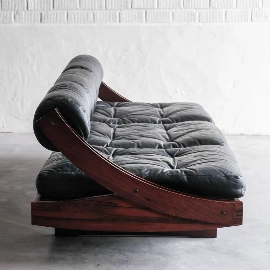 A stylish and modern curved chaise lounge