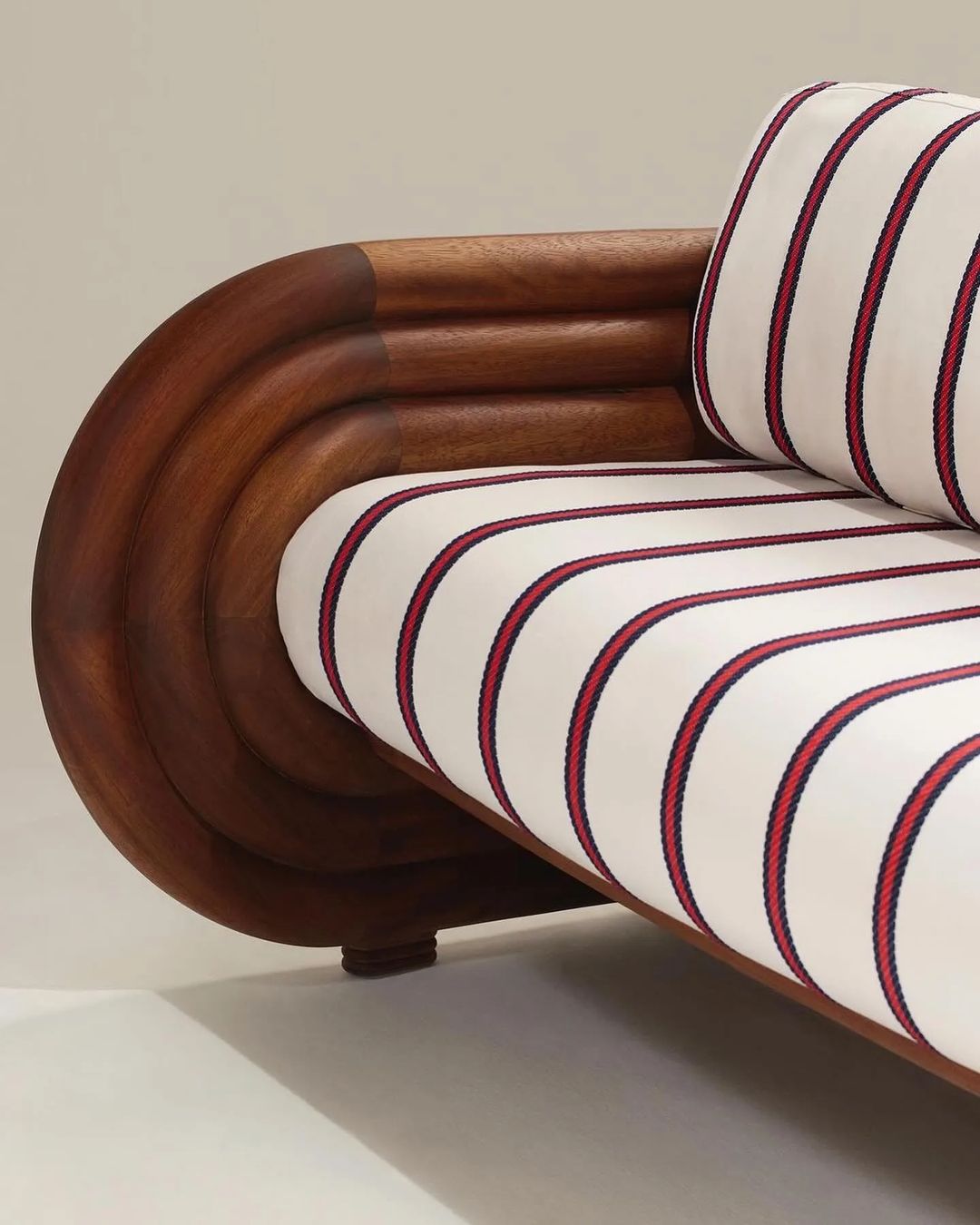 A luxurious wooden-framed sofa with striped upholstery