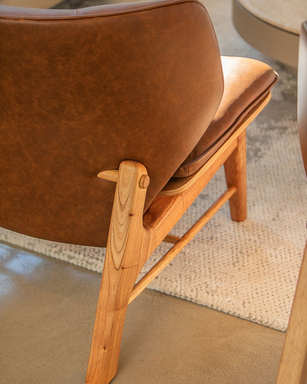 A tasteful leather and wood chair