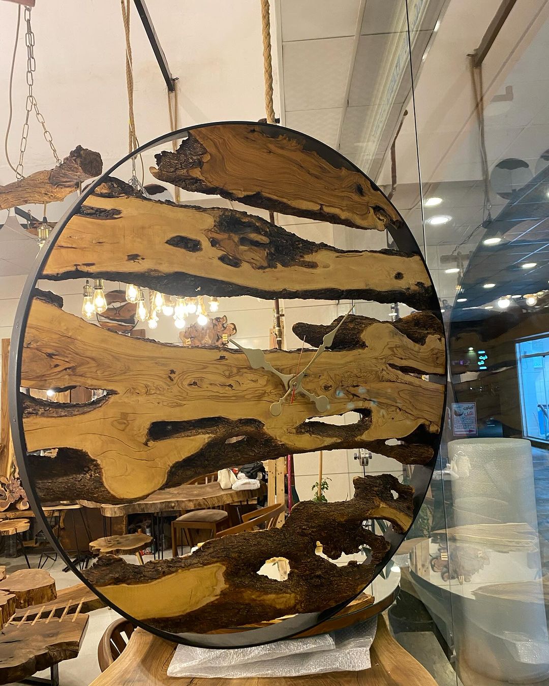 A unique circular mirror framed with raw wood