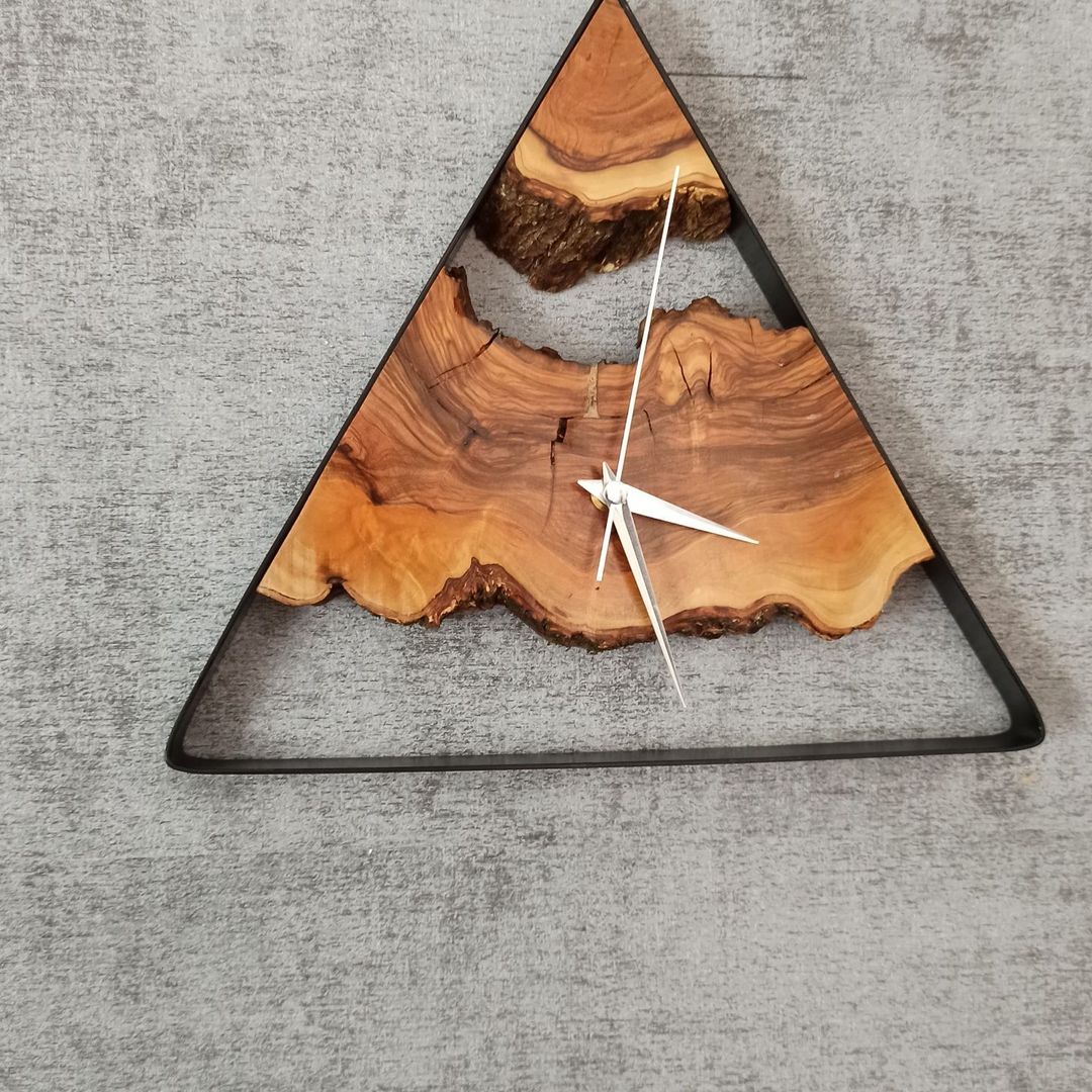 A unique wooden clock with raw edges in a triangular metal frame