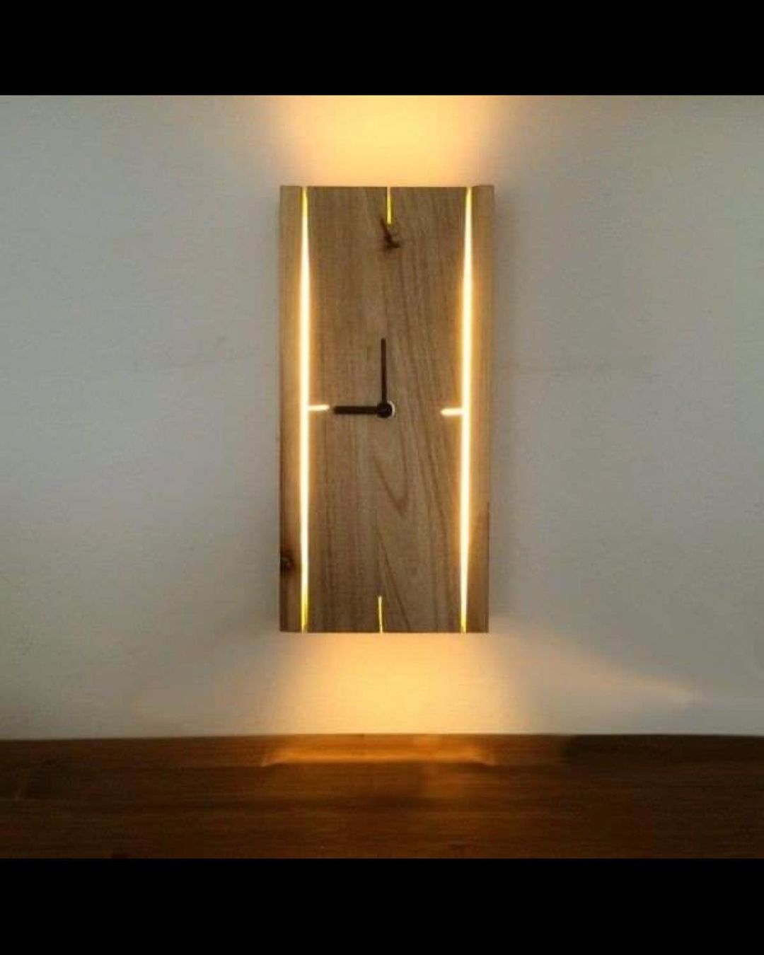 A unique wooden wall clock with glowing edges