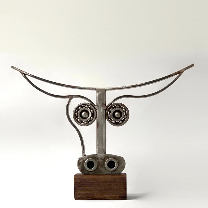 Abstract metal sculpture resembling a stylized owl