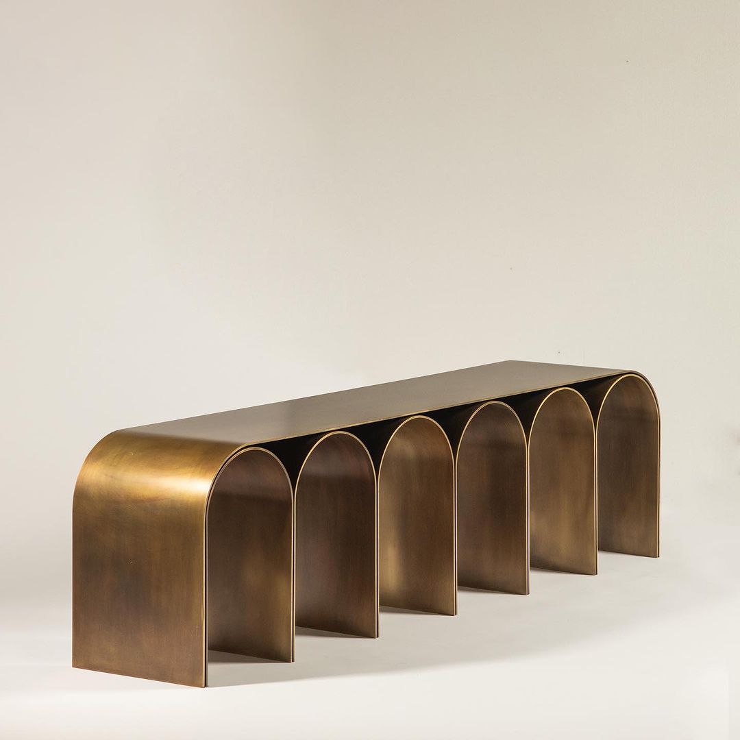 Architecturally inspired bronze-finished metal console with arch motifs