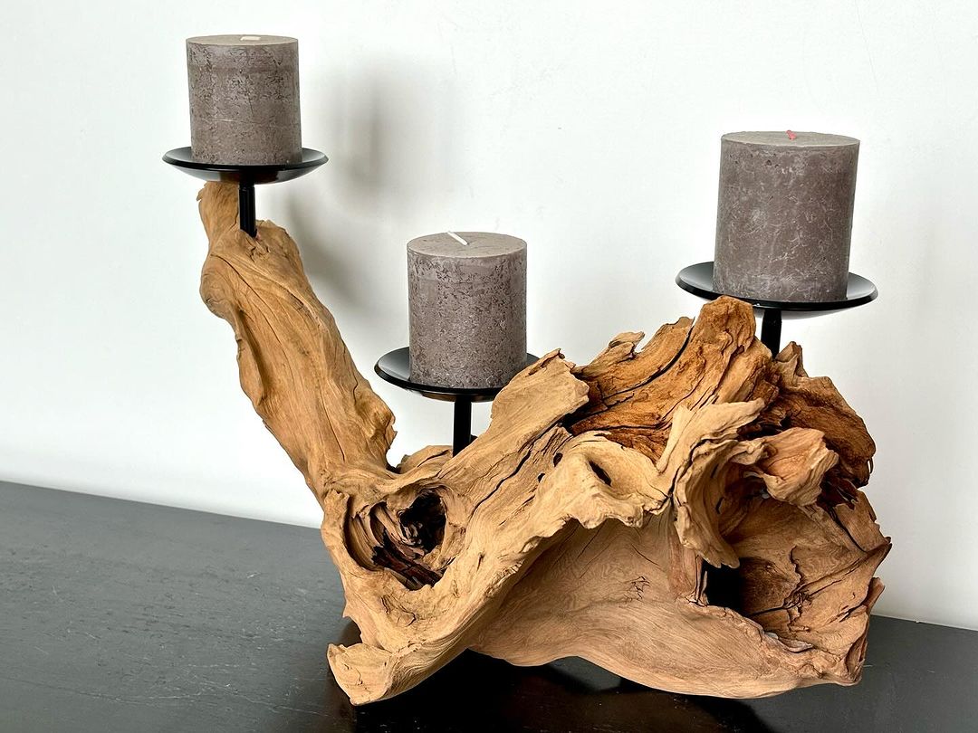 An artistic candle holder with an organic wooden base