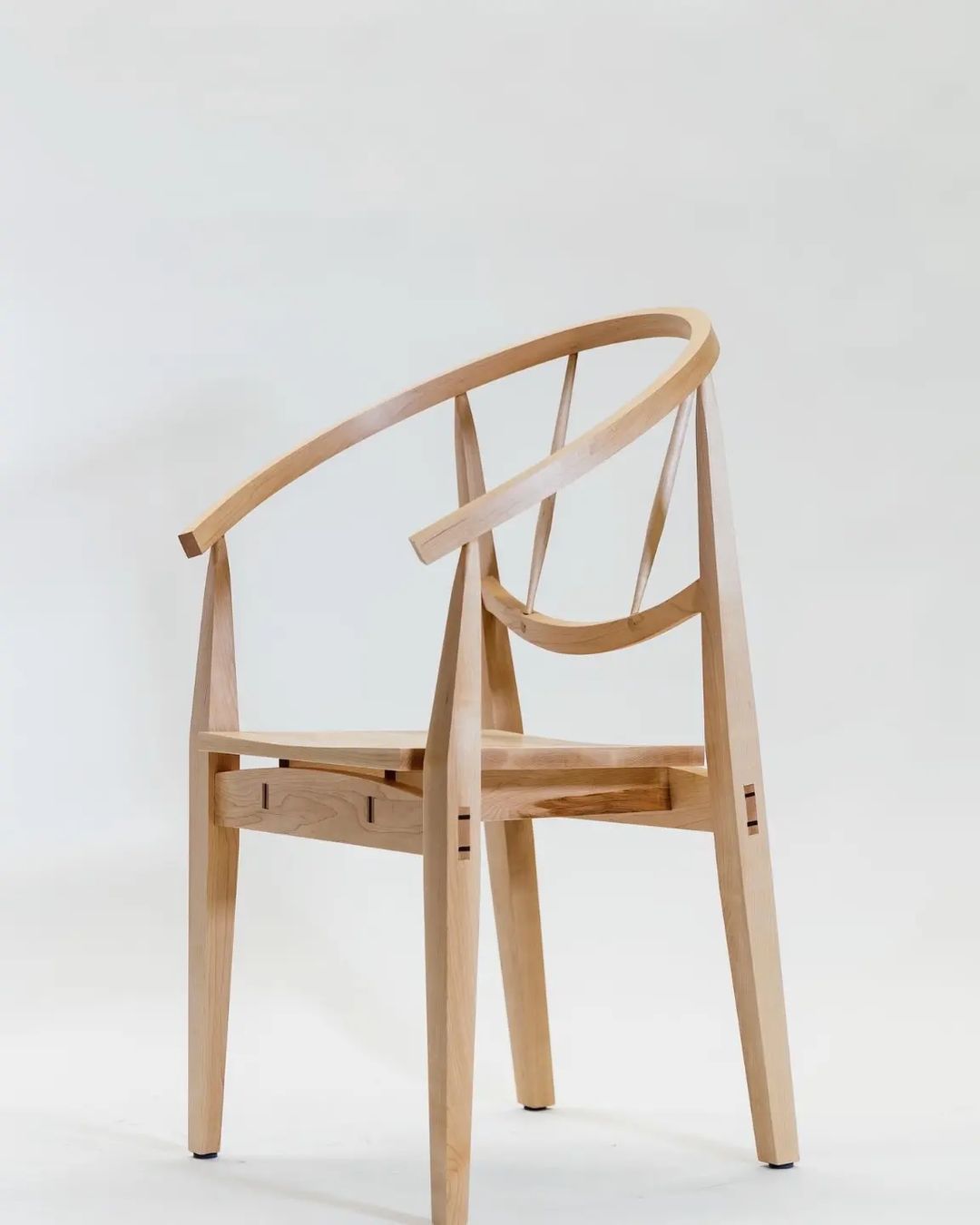 A unique wooden chair with an intricate and flowing design