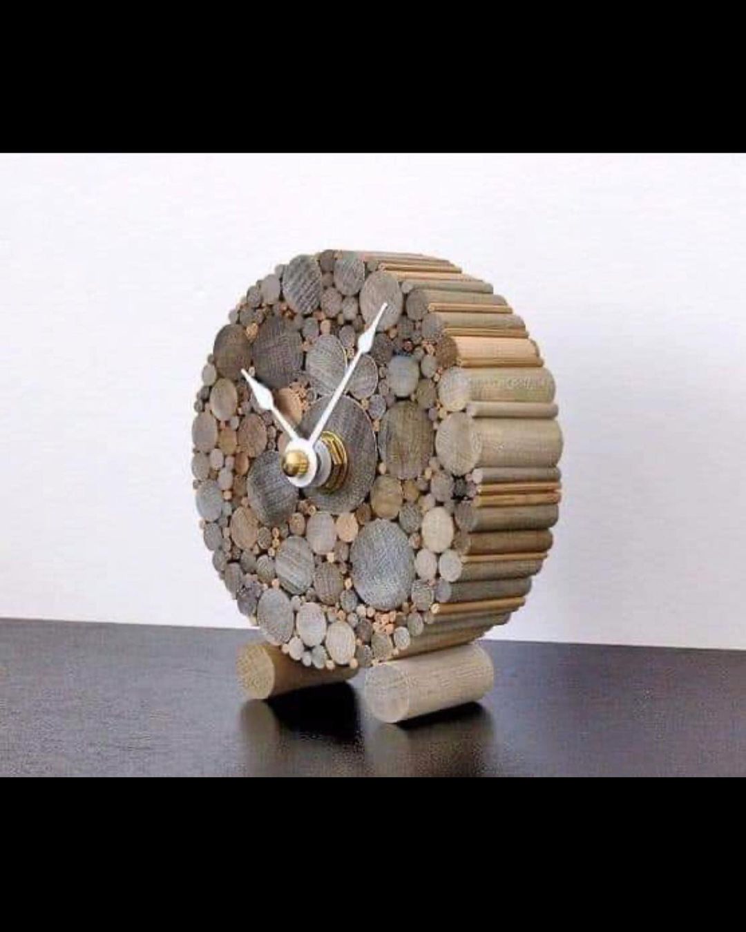 A creatively designed clock made from assorted wooden pieces and stone textures