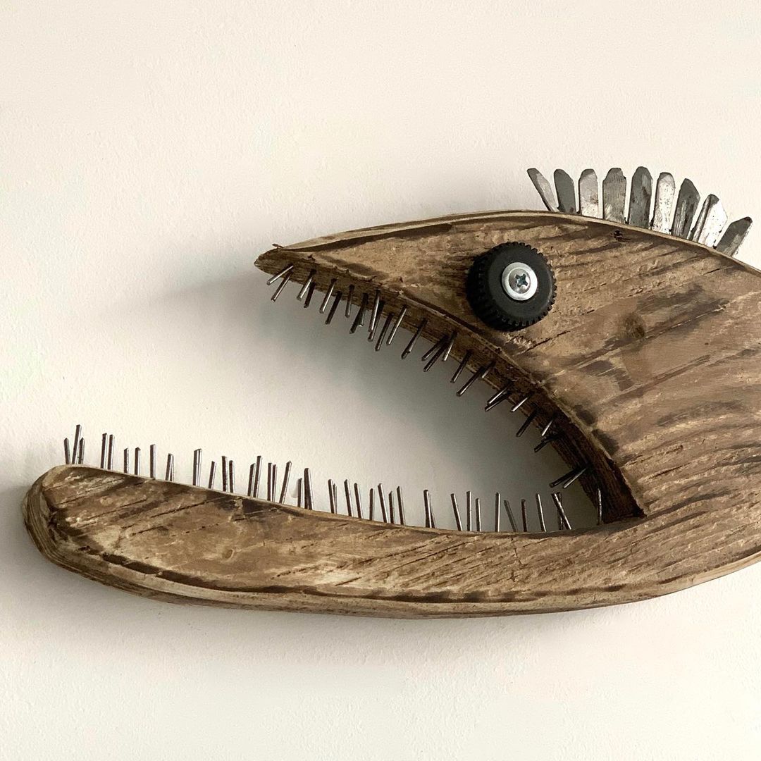 A unique wooden wall sculpture resembling an eye