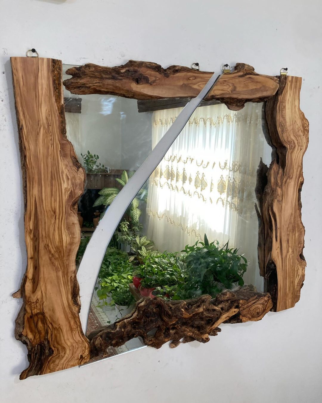 A unique mirror framed with natural, uneven wooden edges