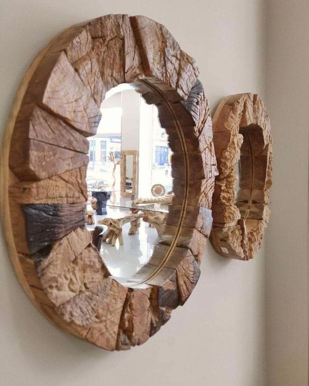 A wooden mirror with a unique split design revealing a reflective surface