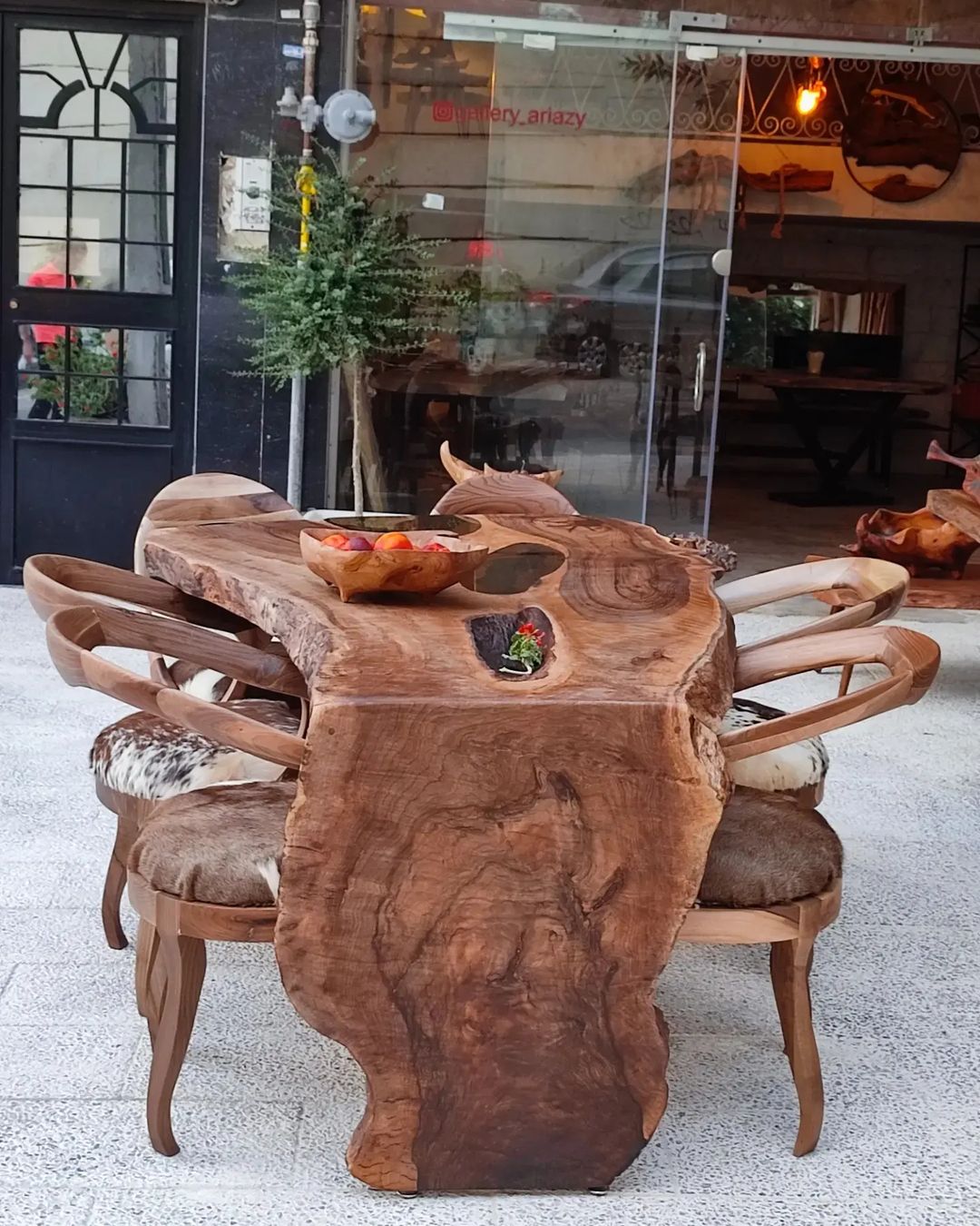 A unique wooden dining table with irregular edges and matching chairs