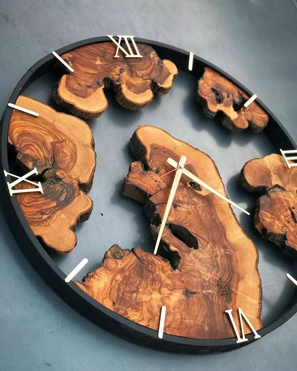 A unique wall clock made of sliced wood pieces set within a circular frame