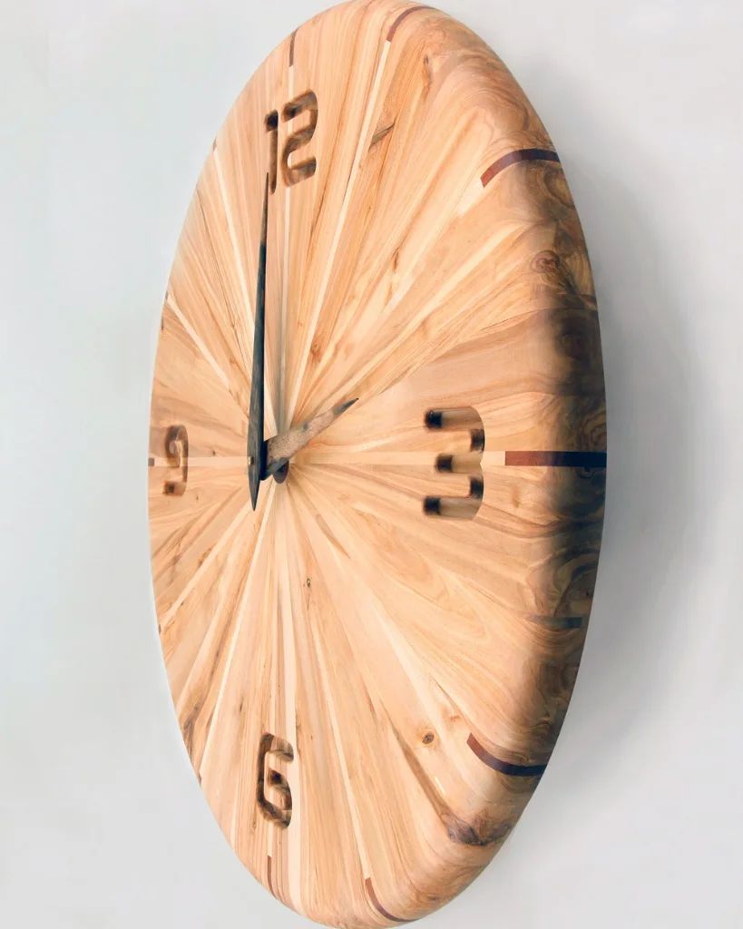 A uniquely crafted wooden wall clock with prominent numerals