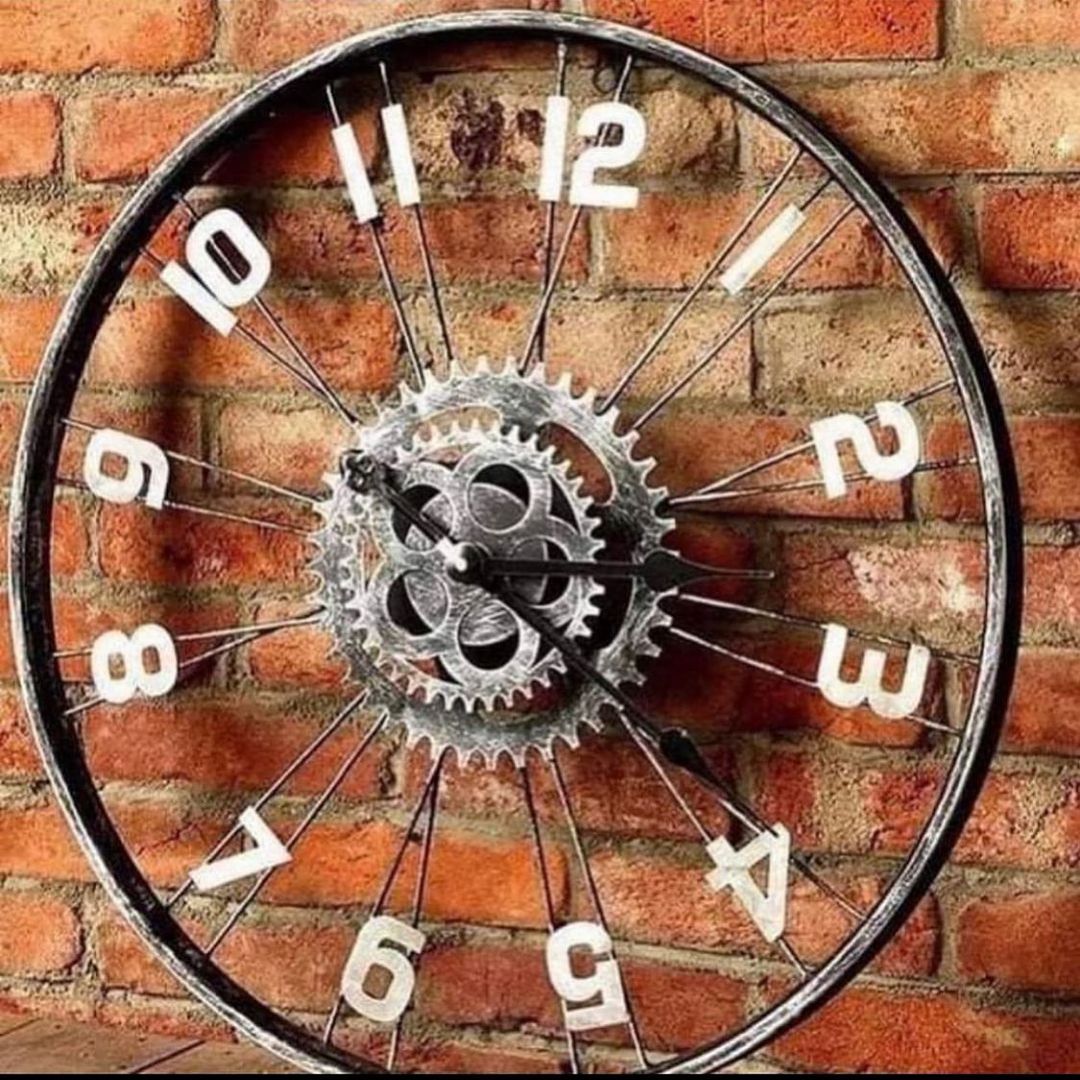 An inventive wall-mounted clock fashioned from a repurposed bicycle wheel, complete with a brick backdrop