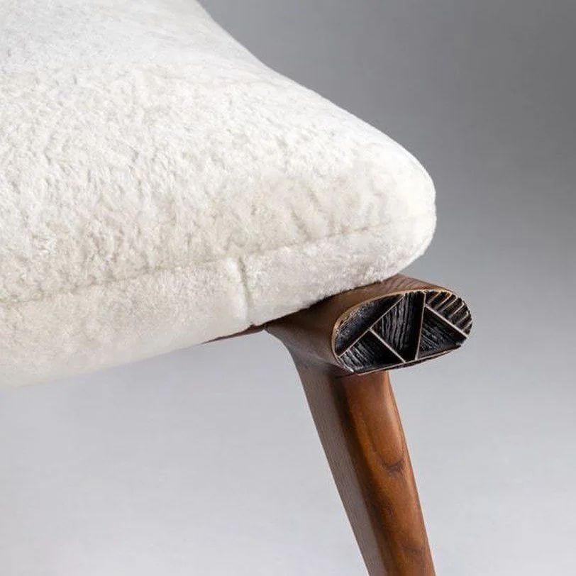 A finely crafted chair leg with intricate, carved details