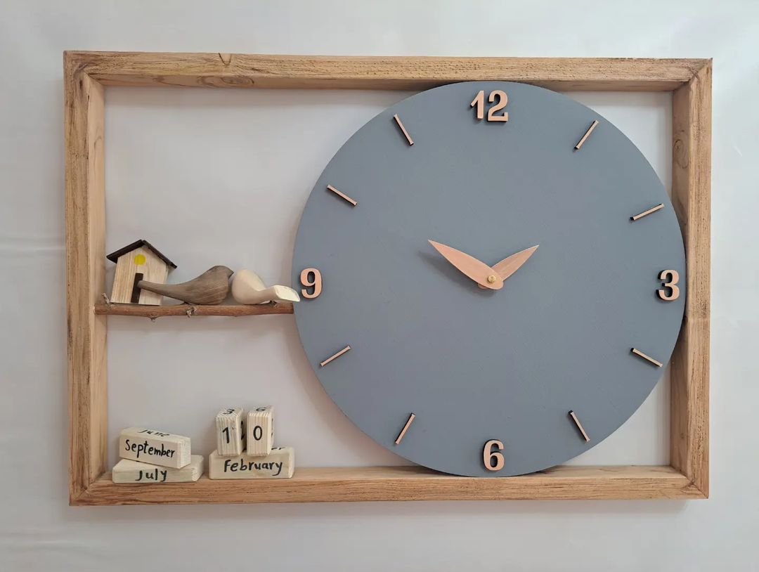 A charming wall clock embedded into a wooden frame with a whimsical bird and miniature house decoration