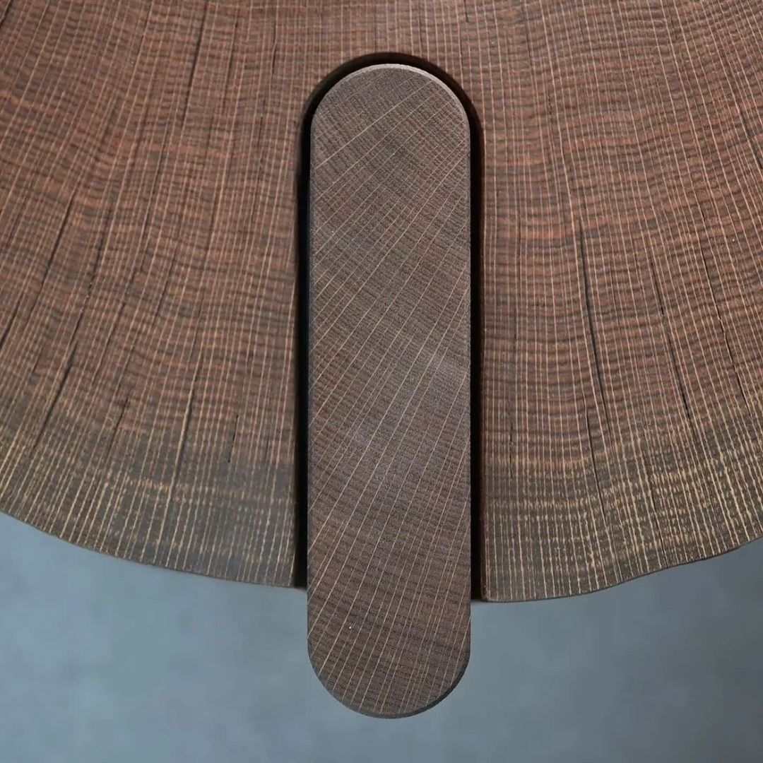 A unique circular wooden table with a central cutout