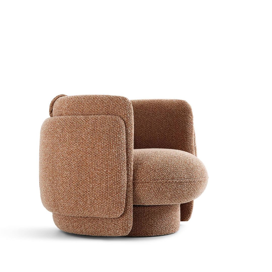 A cozy brown fabric armchair with a plush design and soft texture