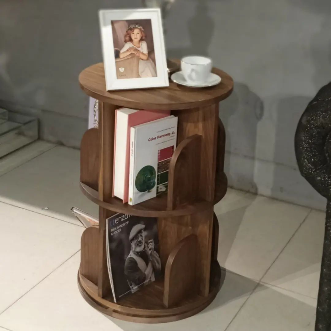 A cozy reading nook with neatly arranged books and a cup of tea on a wooden side table