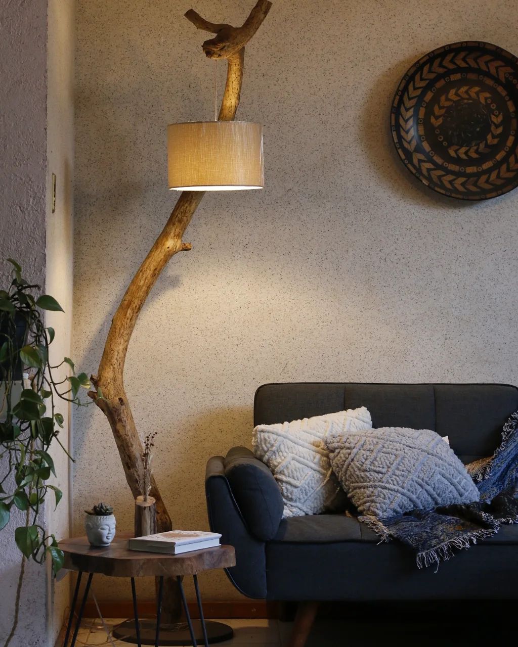 A cozy corner with a unique floor lamp made of a natural branch