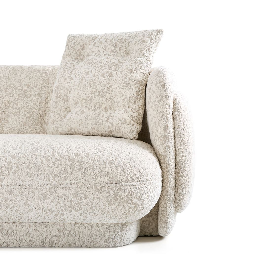 A close-up view of a comfortable sofa with textured fabric