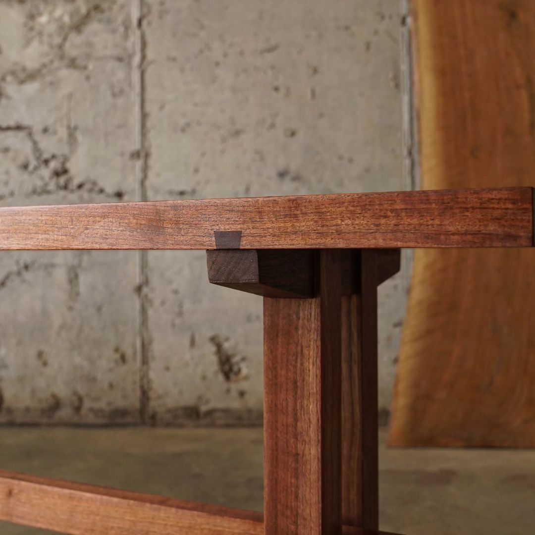 A close-up view of a wooden table's corner joint