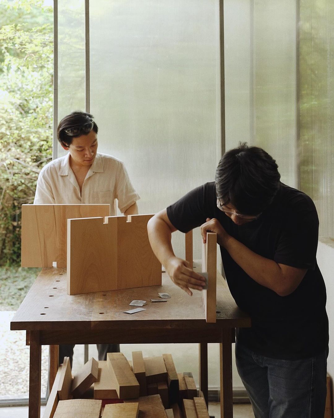 Two individuals engaging in woodworking