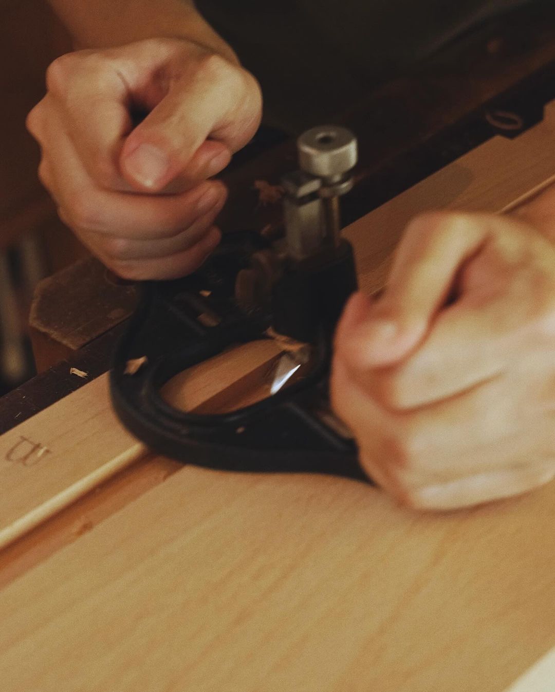 Person working precisely on wood crafting