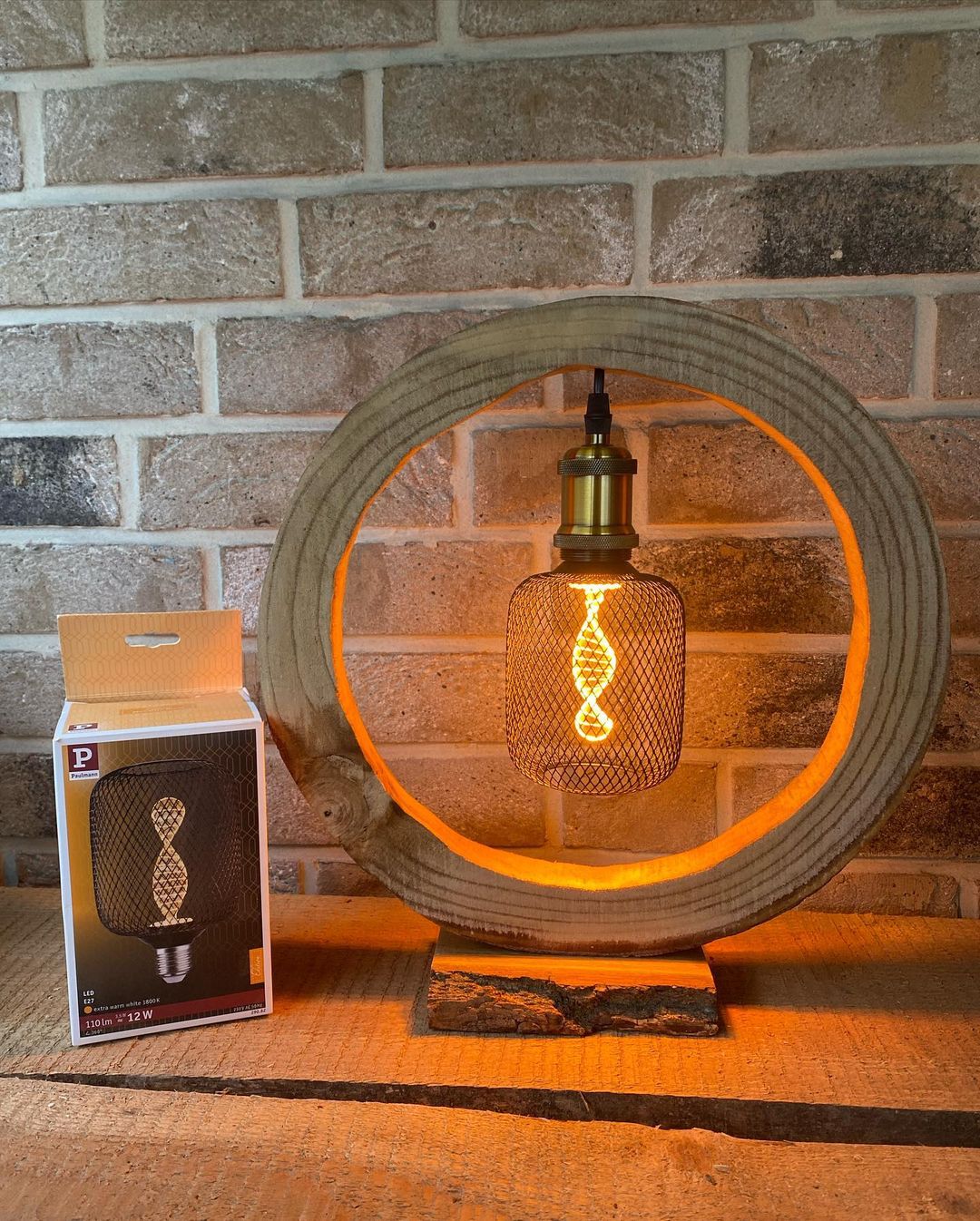 A unique lamp made from a circular section of concrete pipe, with a stylish filament LED bulb