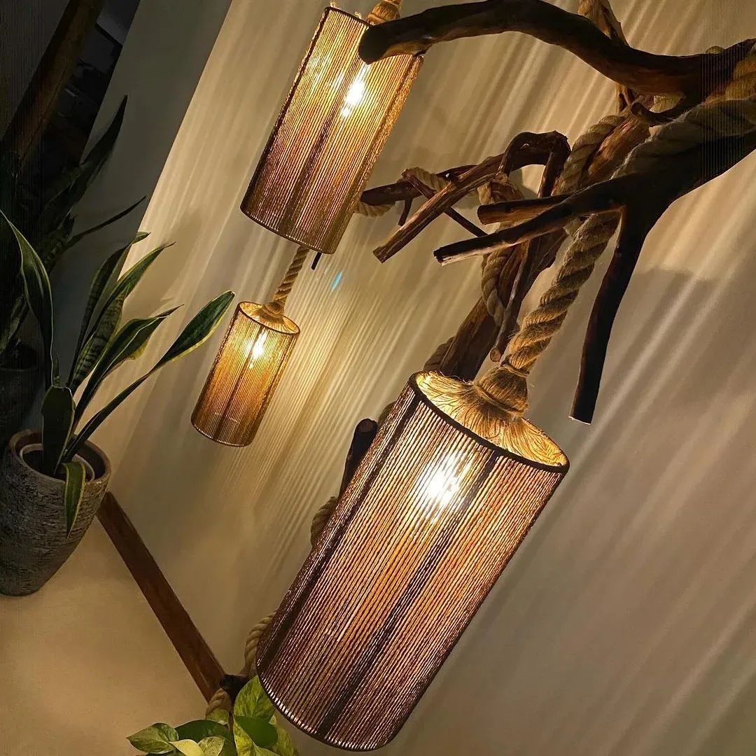 Creative tree branch lamp design with woven shades emitting a warm ambient light