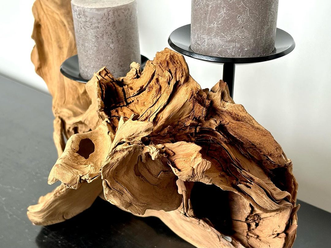 A unique piece of driftwood serving as a rustic candle holder