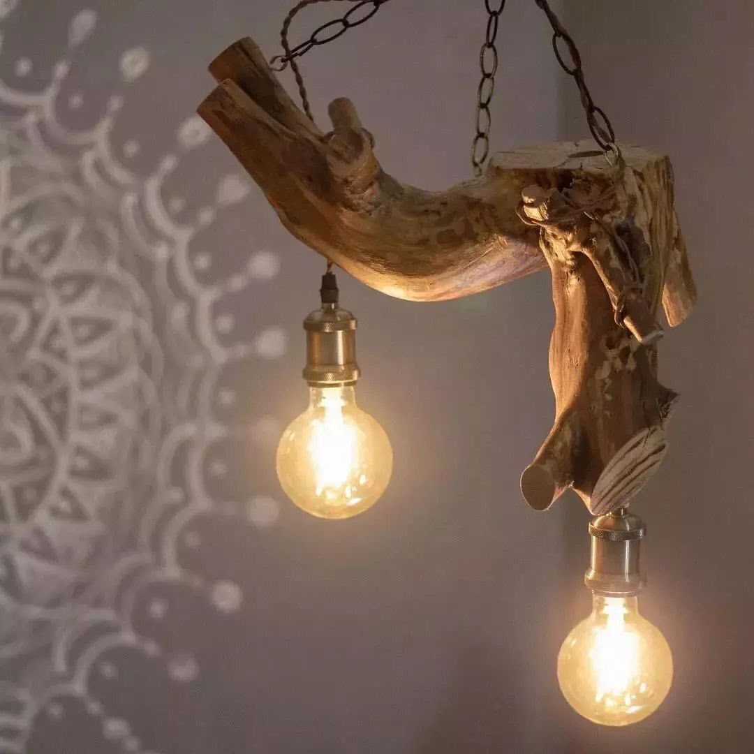 A unique and rustic light fixture crafted from a driftwood branch