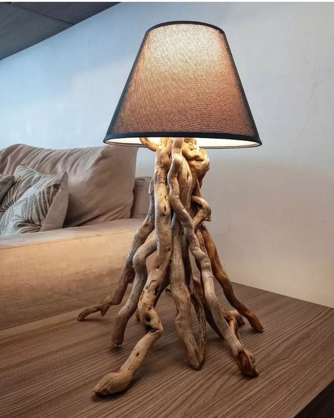 A unique table lamp with a base made of intertwined driftwood branches