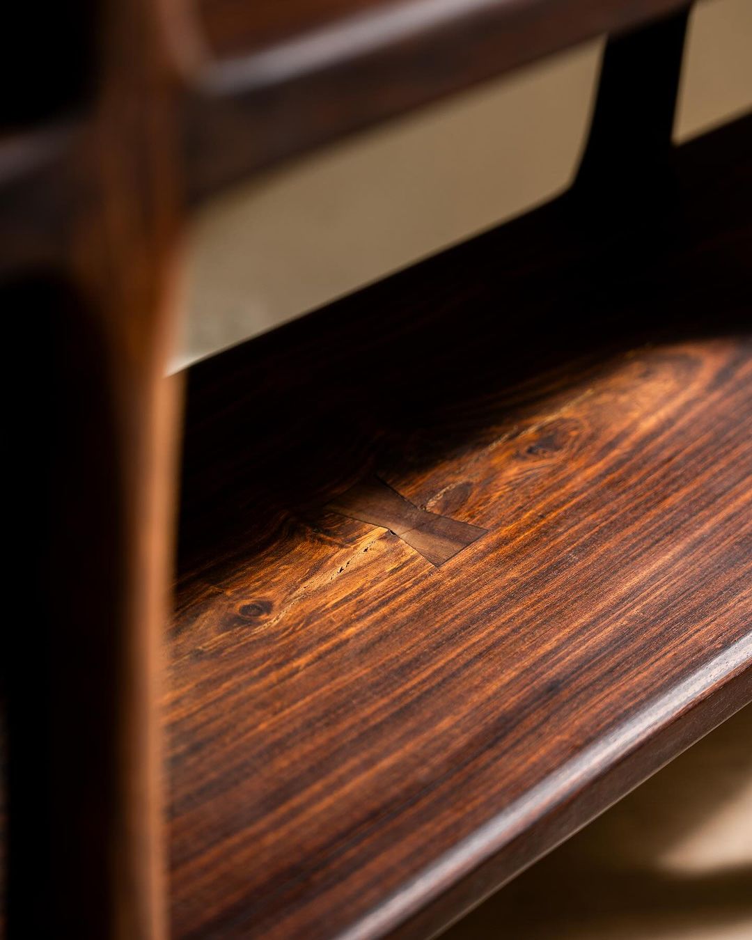 Close-up view of a wooden chair highlighting the wood grain and craftsmanship