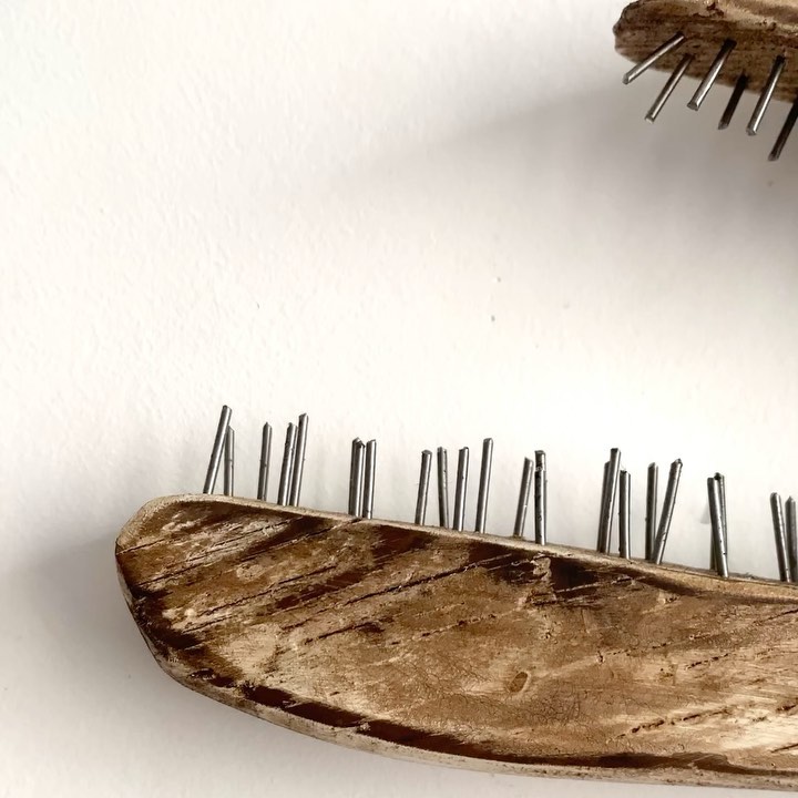 A rustic handcrafted wood and metal brush