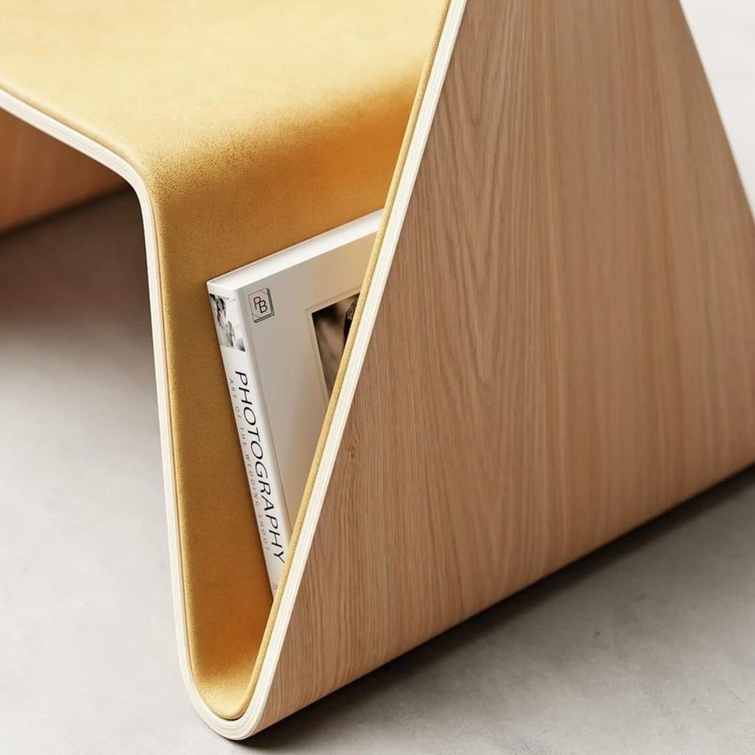 A cleverly designed wooden bench with cushioned seating and a built-in book shelf