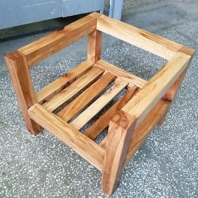 A wooden chair frame with no upholstery or cushions, featuring a sturdy construction.