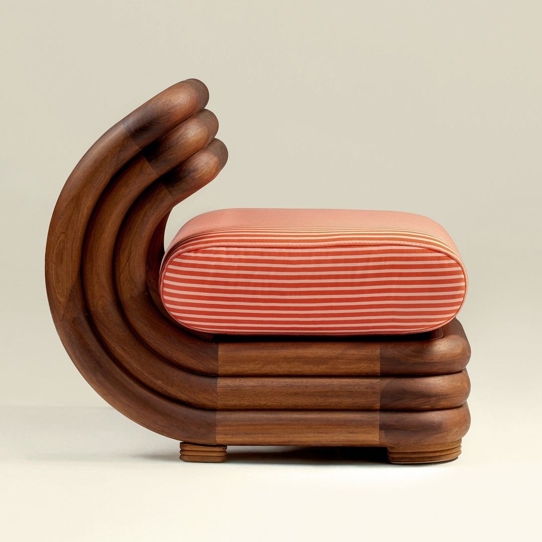 A uniquely crafted wooden chair with a hand-shaped backrest