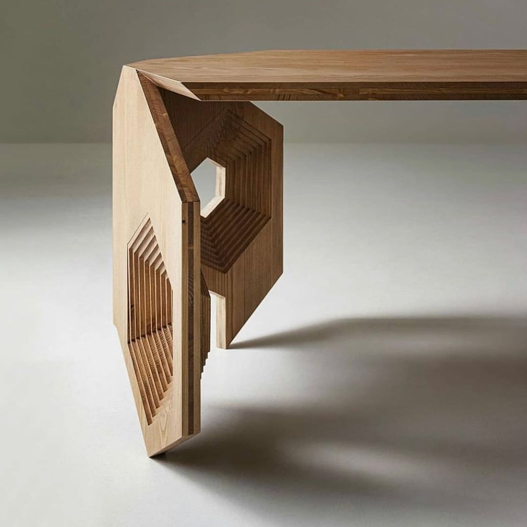 A uniquely crafted wooden table with artistic geometric leg design