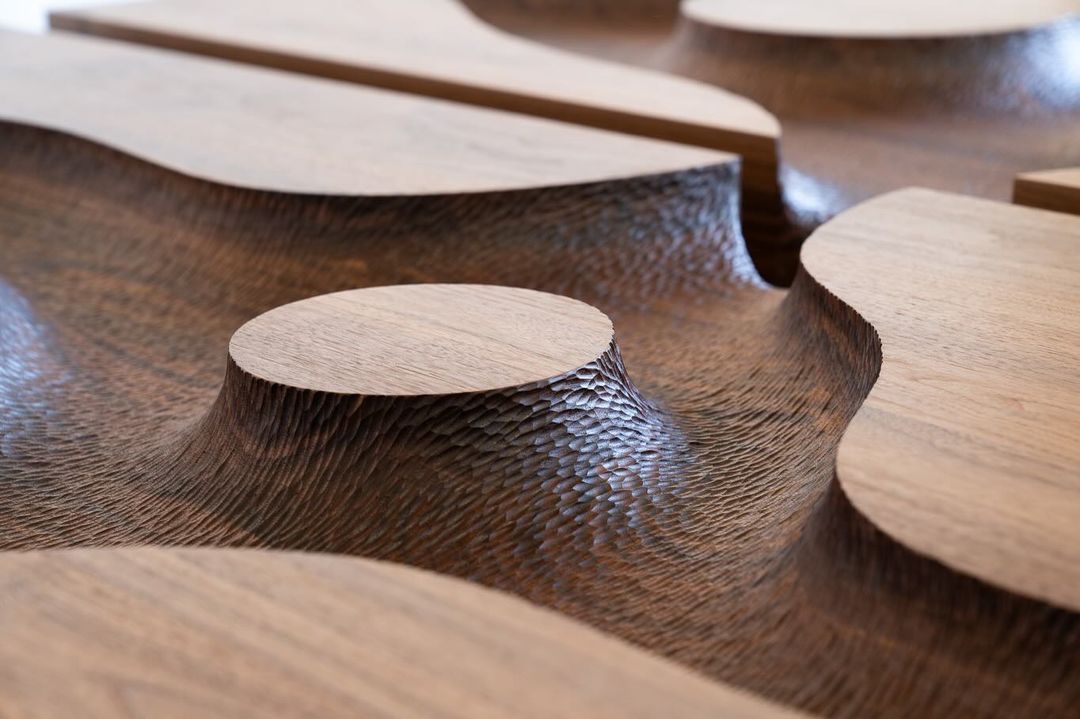 Sculpted wooden surface displaying intricate texture