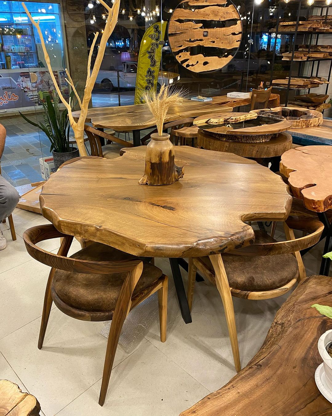 A unique live edge wood dining table with matching curved chairs