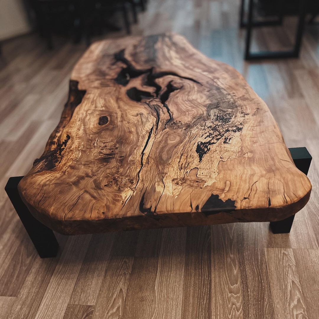 A unique live edge wooden coffee table with distinct natural patterns and textures.